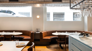 Infinity Constructions’ completed interior fit-out for Nomad Sydney featuring communal tables and pendant lighting