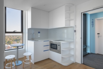 Fully furnished student room at Scape Kensington with natural light and integrated storage