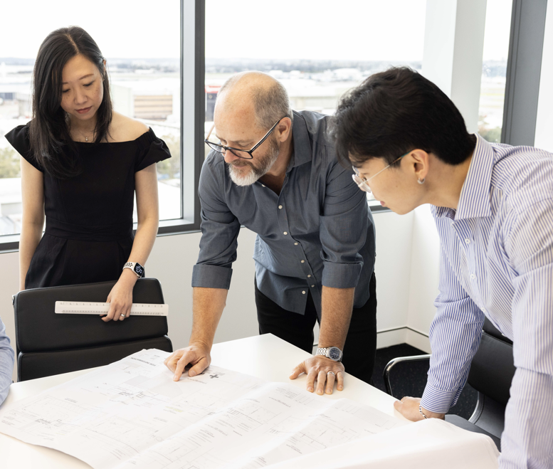 Sydney Construction Team Looking At Plans