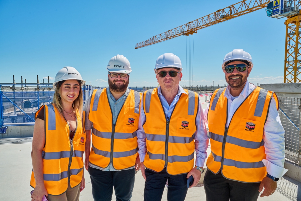 Infinity Constructions team celebrating topping out milestone at Atura Hotel Oran Park