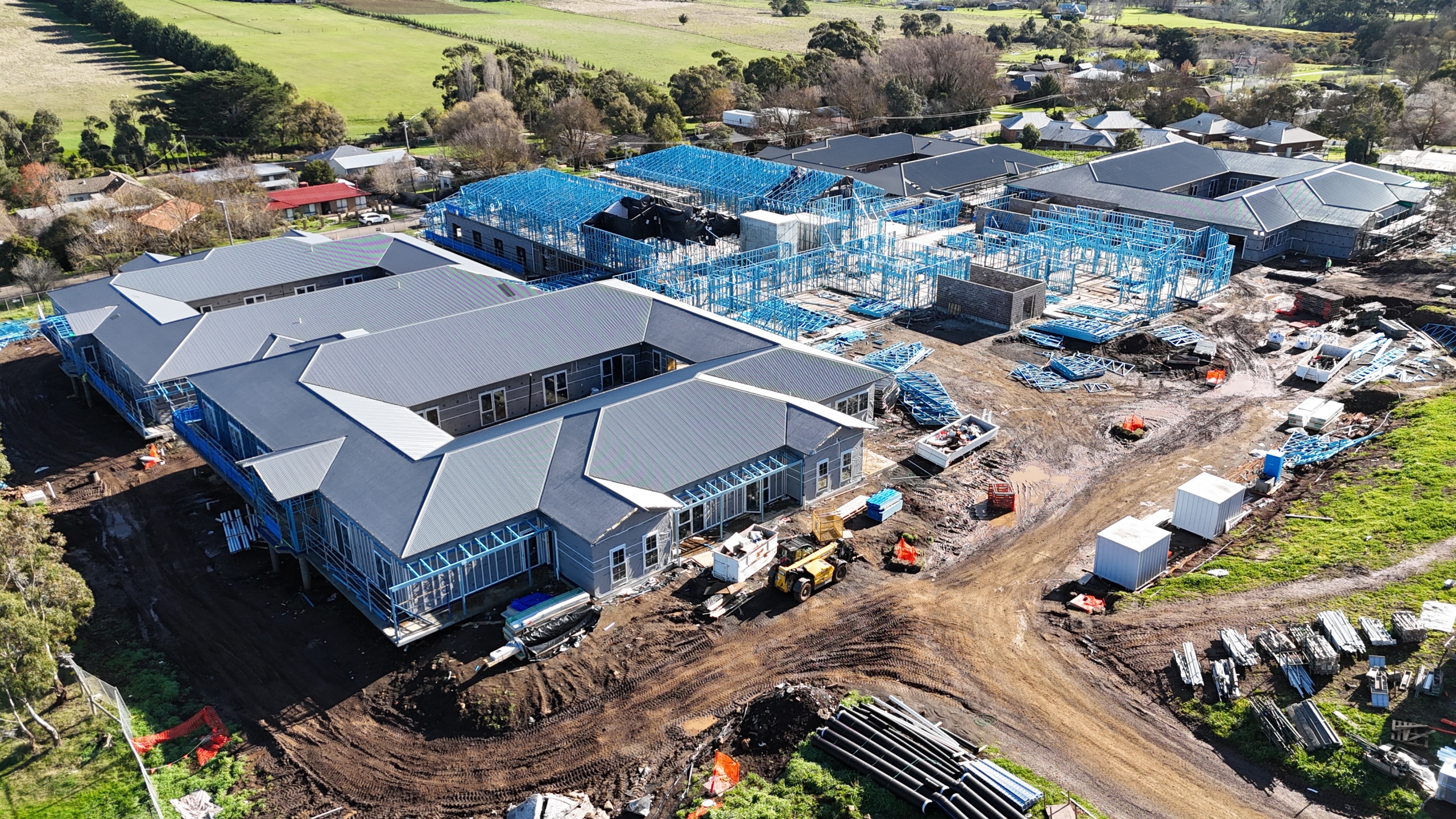 Drone view across the Embracia Aged Care Kyneton buildings, with roofing completed and steel framing underway.