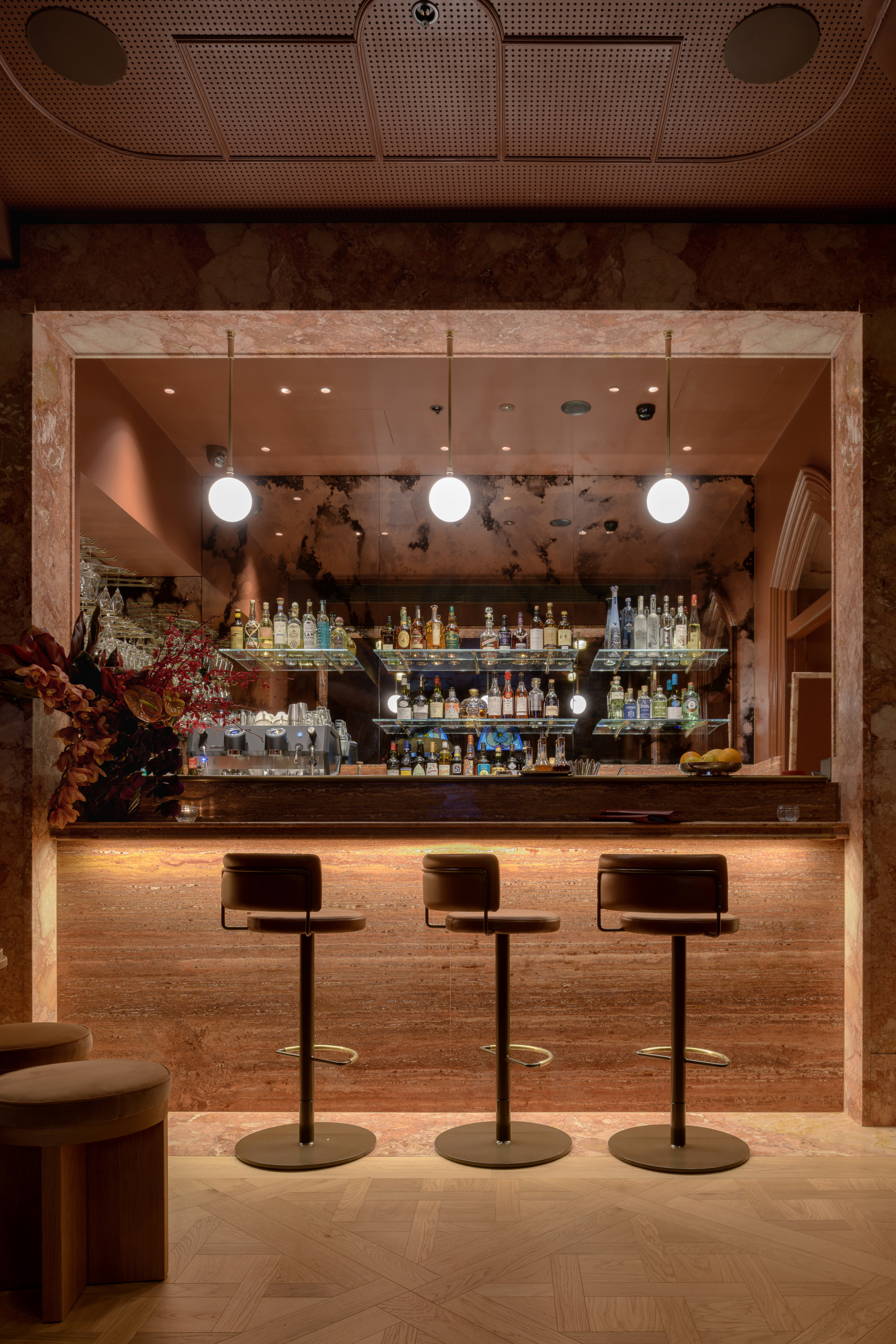 Bar Privé cocktail bar with bespoke stone counter and illuminated bottle display