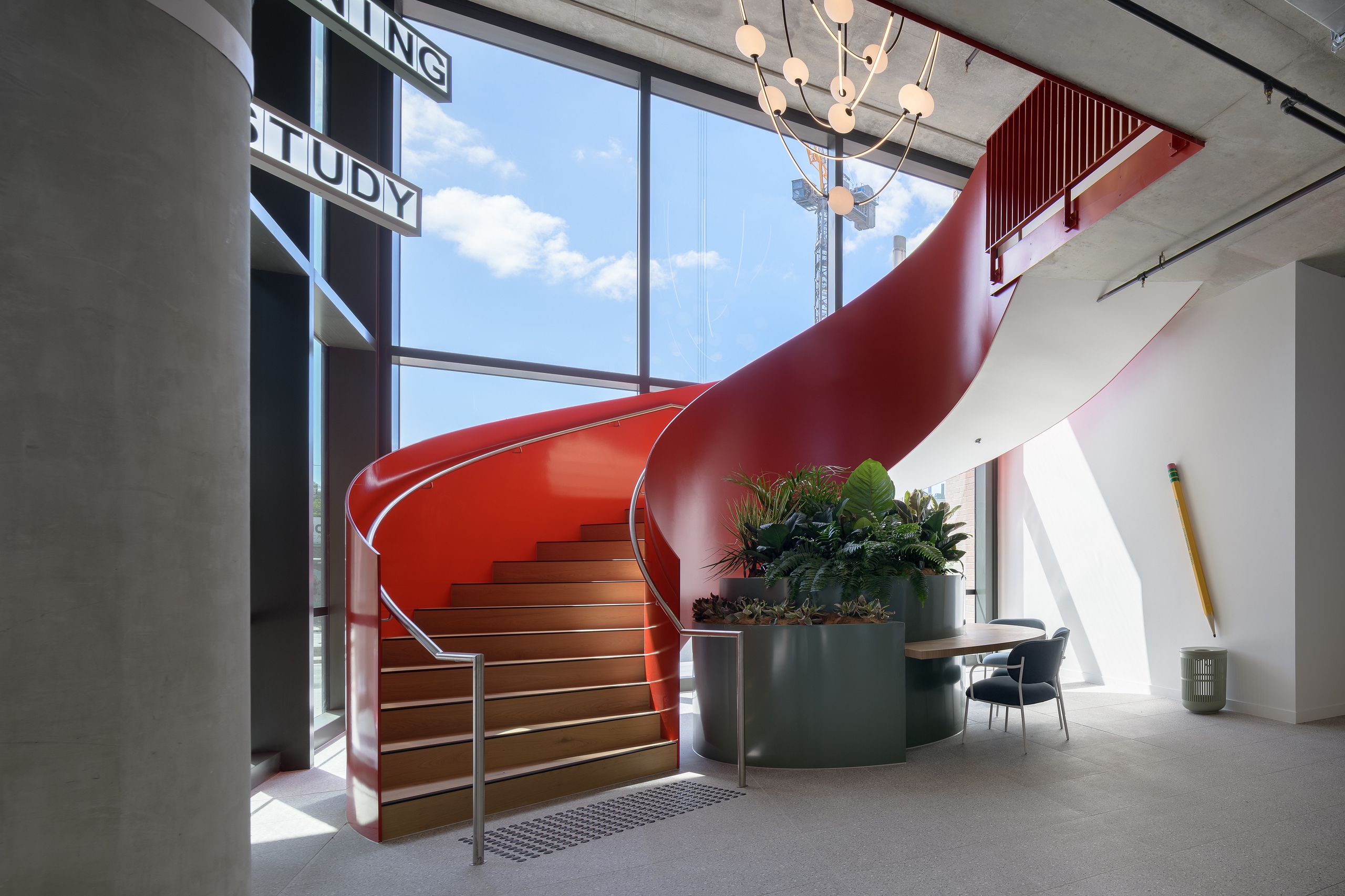 scape lachlan student accommodation feature staircase kensington Red feature staircase and integrated study area at Scape Lachlan student accommodation in Kensington