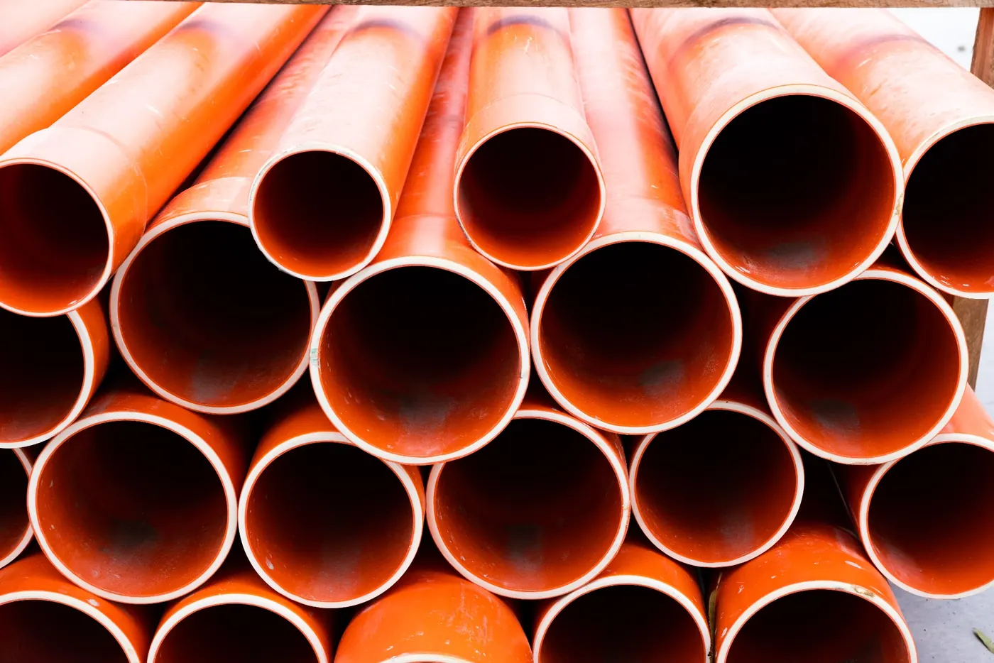 commercial drainage pipes infinity constructions Orange drainage pipes ready for installation on a commercial construction project