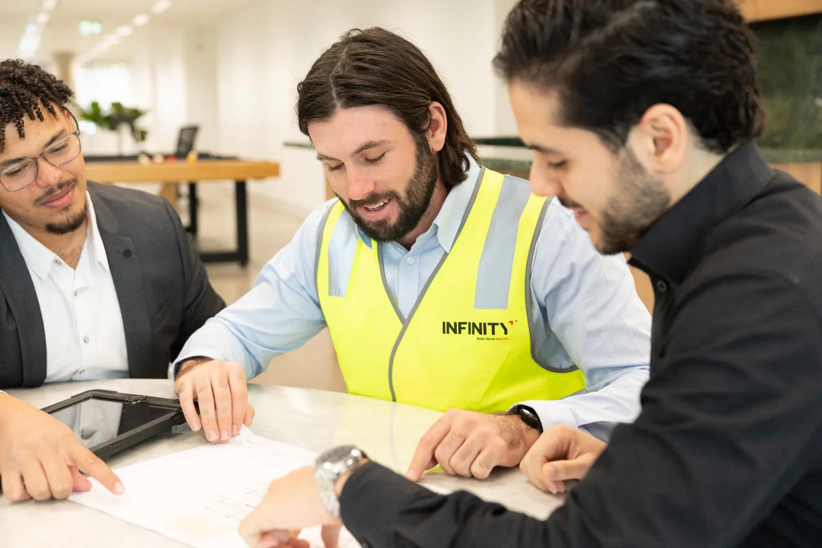 infinity constructions estimating team tender review Infinity Constructions estimating team reviewing construction tender plans