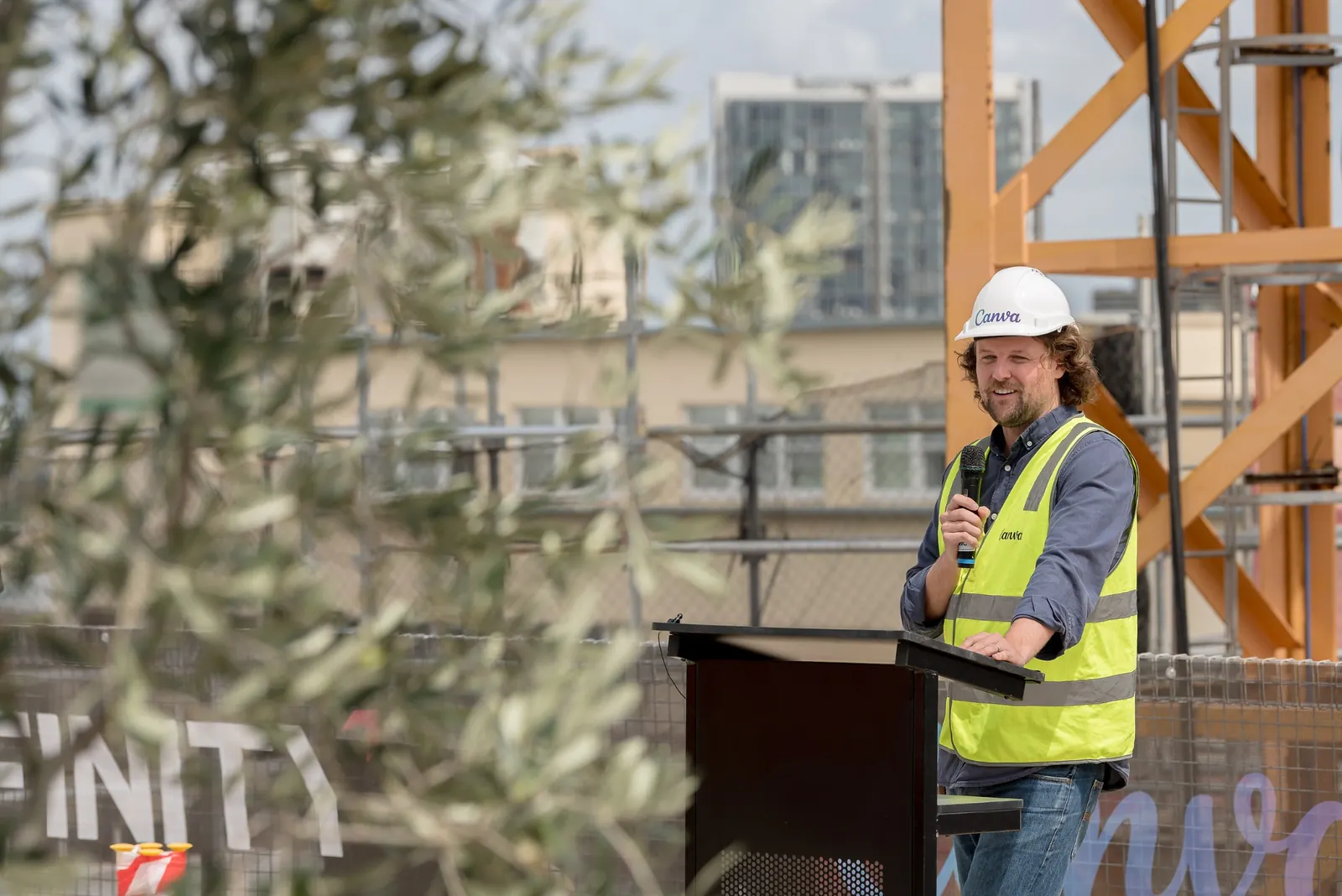 Canva representative addressing guests at the Sydney Campus topping out ceremony