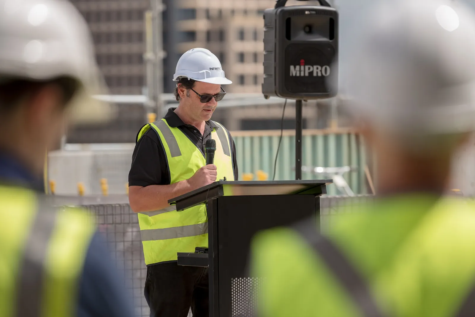 Infinity Constructions project representative delivering an address from the podium
