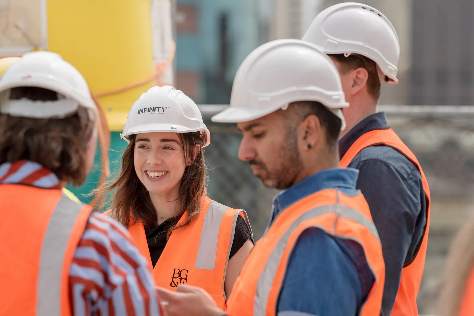 Site visitors talking together during the Canva Sydney Campus topping out event