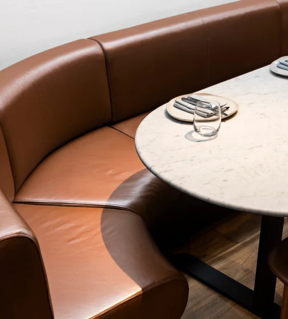 Cover Infinity Constructions hospitality project – Nomad Sydney's kitchen seamlessly integrated into dining space